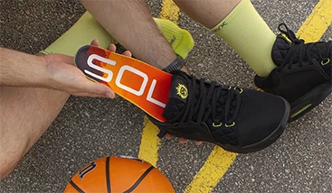 two basketball players holding their sole footbeds