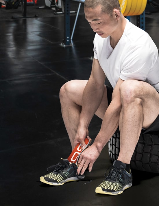 person putting footbed into shoe